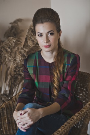 The girl thoughtfully sitting in a chair.の写真素材