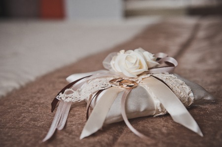 Decorative pillow with wedding rings.の写真素材