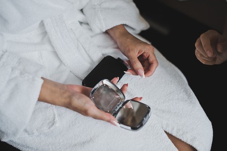 A woman holding a mirror.の写真素材