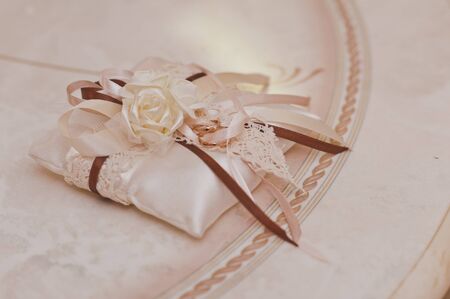 Decorative pillow with wedding rings.の写真素材