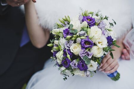 The bride is holding a bouquet of flowers.の写真素材