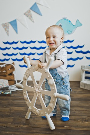 A little boy holds the wheel.の写真素材