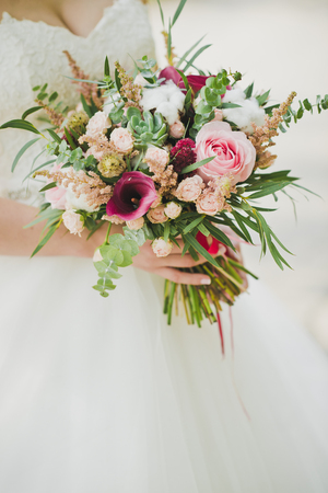 Bouquet of colorful flowers in the hands of the bride.の写真素材