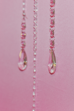 Beads on a pink background.の写真素材
