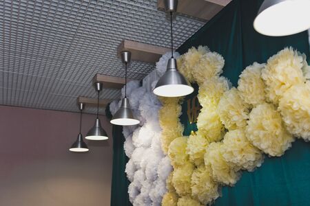 The festive hall is decorated with paper balls.