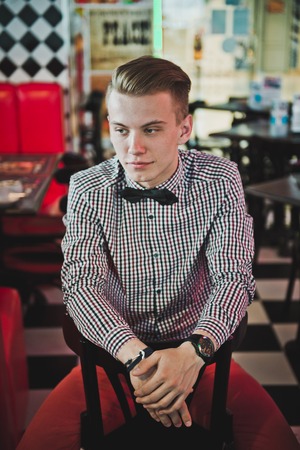 Portrait of handsome young man in a cafe.の写真素材