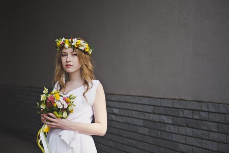 Girl with flowers and a wreath of flowers.の写真素材