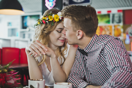 Young couple sitting in a cafe at a table.の写真素材