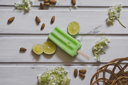 Green ingot fruit ice cream on the table among fruits and berries.の写真素材