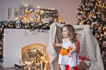 Daughter with mother play around the Christmas tree.の写真素材