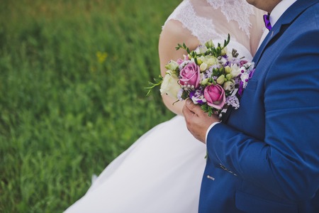 The bride and groom with a bouquet of beautiful flowers.
