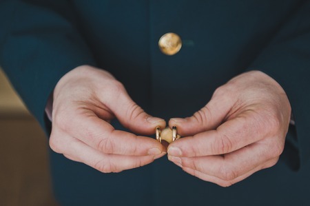 The groom is considering wearing a wedding ring.の写真素材