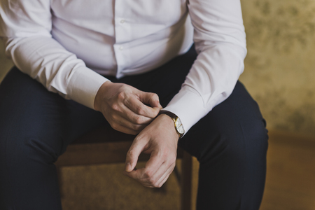 The man straightens his shirt sleeve.の写真素材