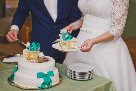 Bride shares wedding cake among the guests.の写真素材