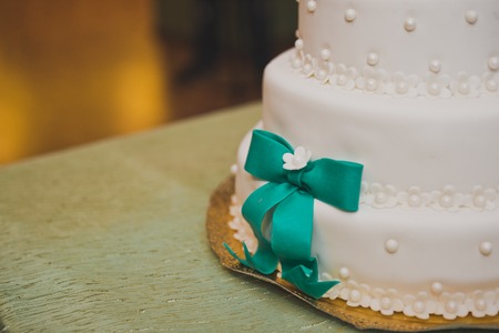 Huge sweet cake decorated with ribbons of mastic.の写真素材