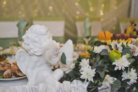 White angel amongst the flowers on the holiday table.の写真素材