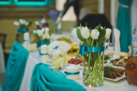 A bouquet of white roses as an element of decoration of the festive table.の写真素材