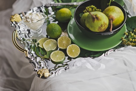 Sliced lemon and pear on a beautiful tray.