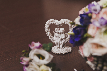 The arms of the angels on a stand in the shape of a heart.の写真素材