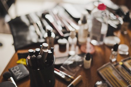 Table with bottles and brushes for makeup.の写真素材