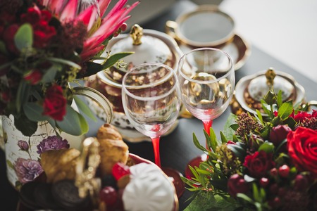 A bouquet of flowers on the table with a Cup of tea.の写真素材
