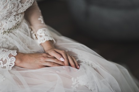 The bride sits nervously rubbing his hands.の写真素材