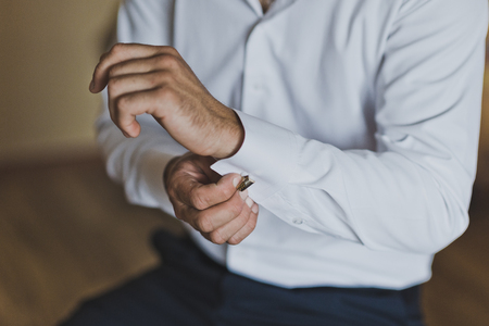 The process of dressing a white business shirt man.の写真素材