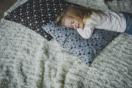 The little girl smiles in her sleep.の写真素材