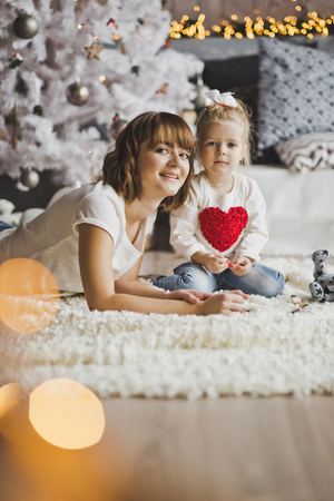 Child and parent play with toys on the floor.の写真素材