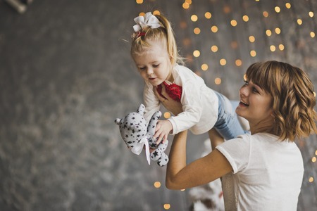 A young mother holding her baby in her arms.の写真素材