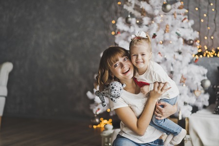 A young mother holding a happy child.の写真素材