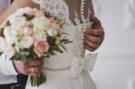 Large photo of hands embracing the newlyweds.の写真素材