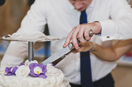 The cake cut and handed out to the guests at the party.の写真素材
