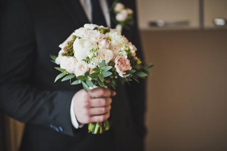 A bouquet of flowers in male hands.の写真素材