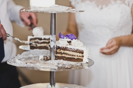 The process of separating a birthday cake for the guests.の写真素材