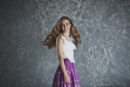 Portrait of slim girl on a background of textured walls.の写真素材