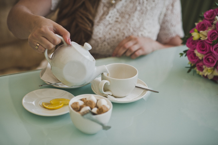The girl pours a Cup of tea.の写真素材