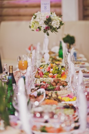 The tables are lined with them dishes of food.の写真素材
