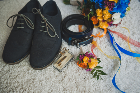 Bright multicolored bouquet and mens accessories on white background.の写真素材