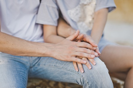 Male and female hands woven together.の写真素材
