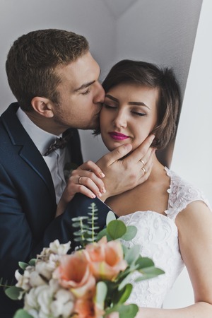 A tender portrait of the newlyweds in the Studio.の写真素材