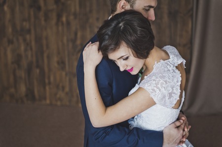 The bride gently hugging the young man.の写真素材