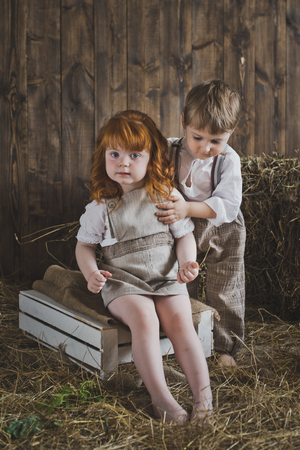 Portrait of children playing in the barn.の写真素材