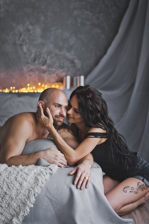 A gentle kiss men and women on the background of lights.の写真素材