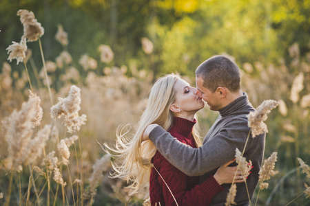 A man and woman admire each other and within the vicinity of reeds.の写真素材
