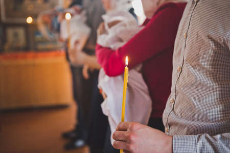Lights of candles in the hands of parishioners.の写真素材