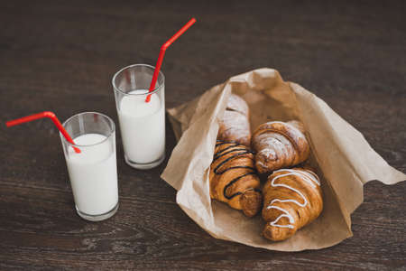 Bag with croissants and glasses of milk for Breakfast.の写真素材