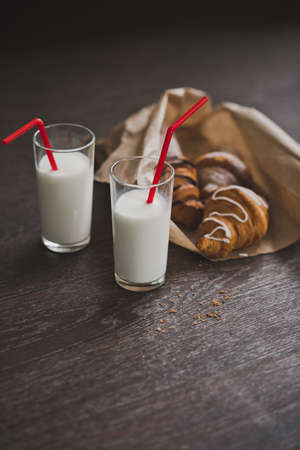 Bag with croissants and glasses of milk for Breakfast.の写真素材