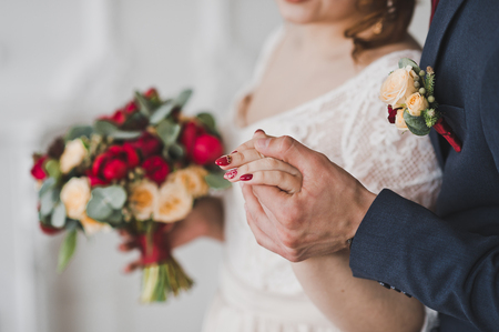 Husband gently takes the hand of his wife.の写真素材