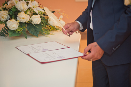 The process of signing an important document with a pen.の写真素材